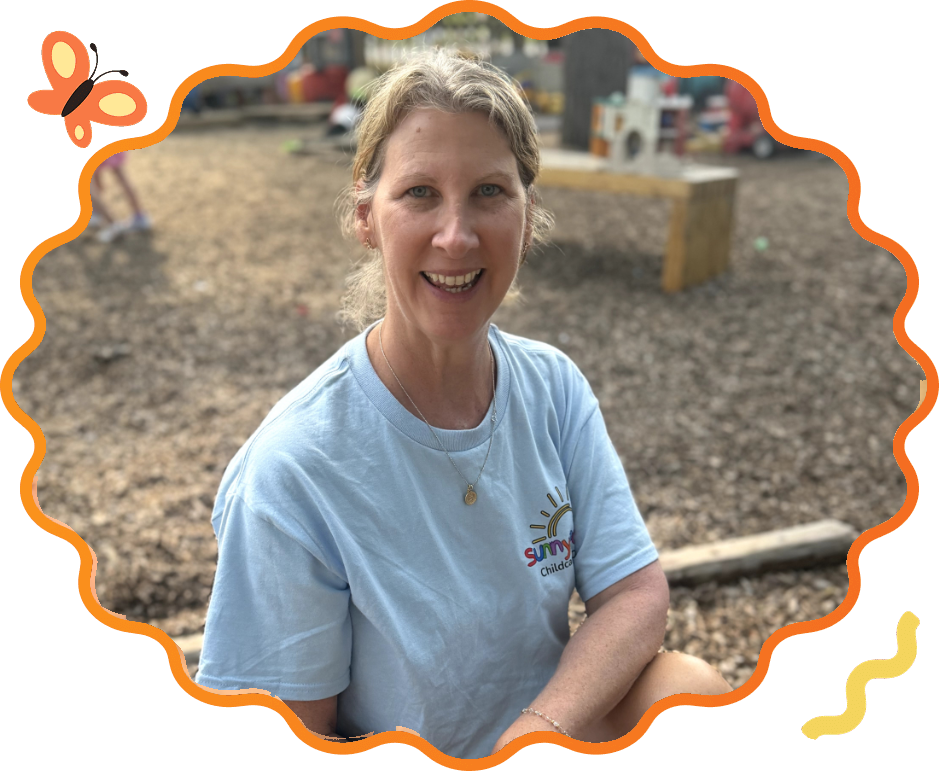 Cindy, a preschool assistant at Sunny Pointe for 10 years, smiling on the playground at our Northville child care center
