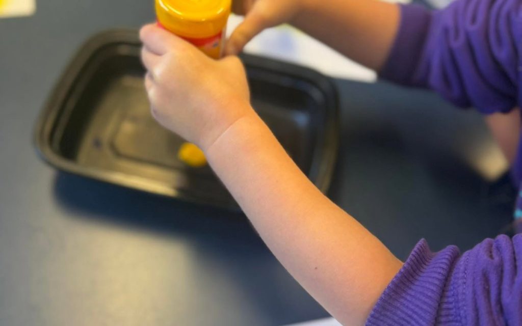 Toddler painting with sponge stamps at Sunny Pointe