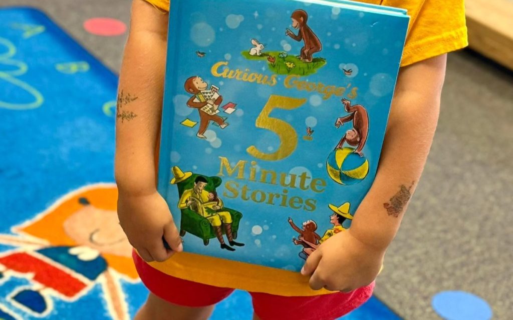 Preschooler holding a storybook at Sunny Pointe