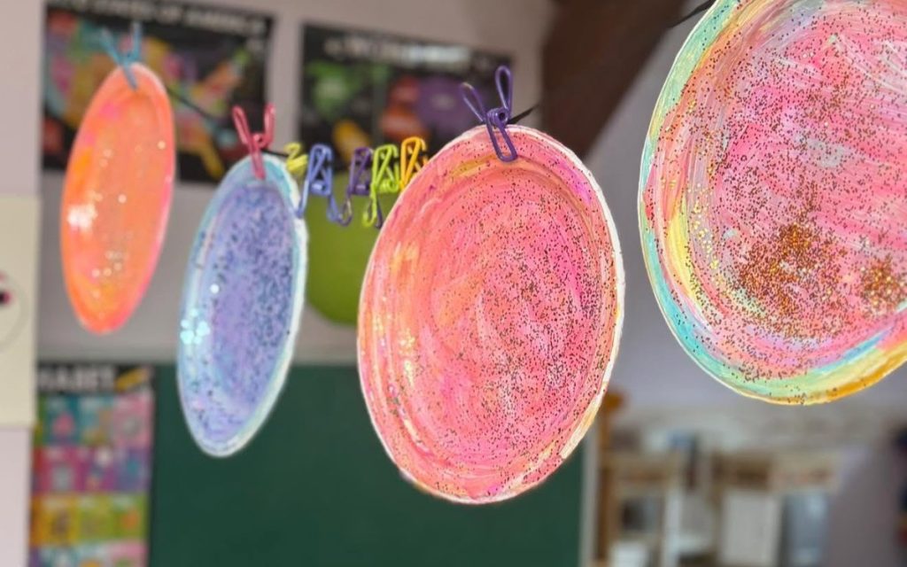 Paper plate planet crafts in a Sunny Pointe classroom