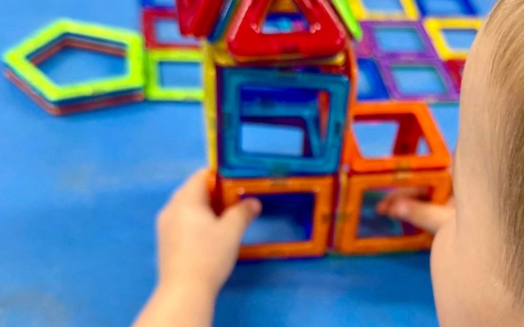 Toddler building with magnetic tiles at Sunny Pointe