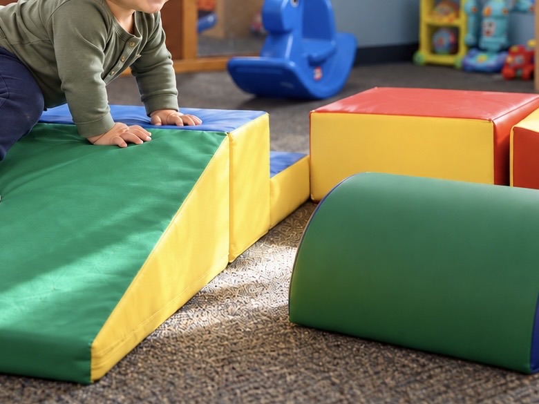 Young toddler climbing soft play blocks at Sunny Pointe Child Care Center in Northville