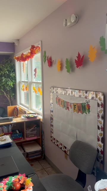 Sunny Pointe preschool classroom in Northville decorated for fall with leaves on the windows